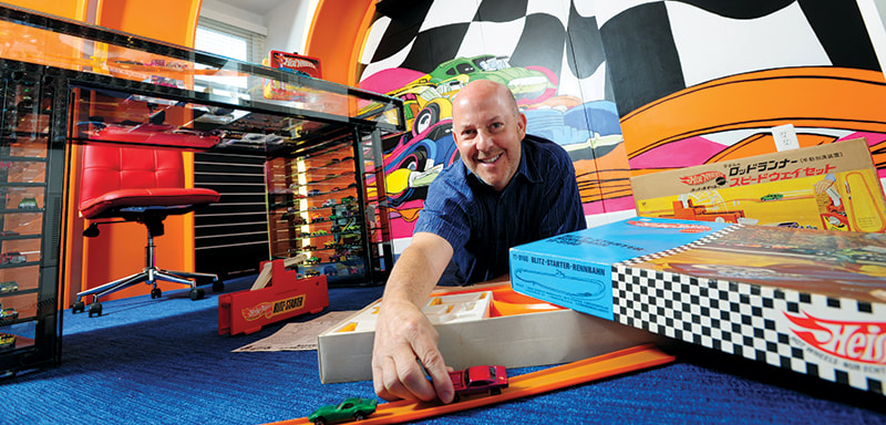 Bruce Pascal shows off his Hot Wheels collection, which includes about 3,000 toy cars, in his Potomac home. Photo by Michael Ventura